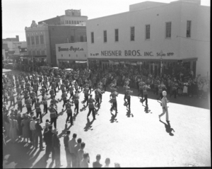 Texas Tech Goin’ Band marching past the Neisner Bros. Building in downtown Lubbock on Broadway Avenue, circa 1940’s- Photo courtesy of the Public Information Collection, University Archives Collection Texas Tech University